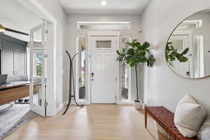 Foyer featuring light wood-style floors and baseboards