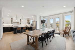 Dining space featuring light wood-style flooring and recessed lighting