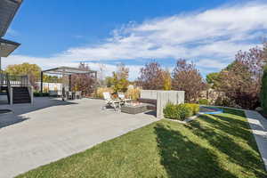 Fenced backyard with a patio and an outdoor fire pit