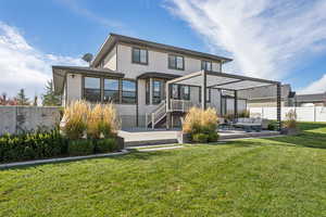Back of property featuring a patio area, stucco siding, and a pergola