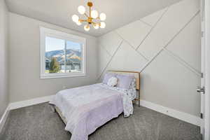 Bedroom featuring carpet flooring and a chandelier