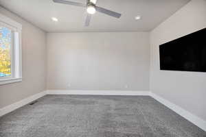 Carpeted empty room featuring recessed lighting and a ceiling fan