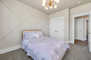 Bedroom with a chandelier and carpet flooring