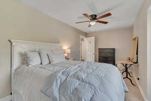 Carpeted bedroom with baseboards and ceiling fan