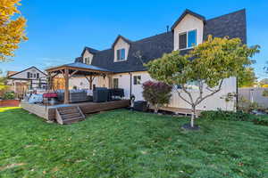 Rear view of property featuring a gazebo, board and batten siding, an outdoor living space, a wooden deck, and a shingled roof