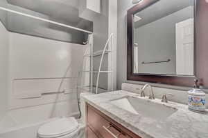 Full bath featuring vanity and  shower combination