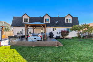 Back of house with board and batten siding, an outdoor hangout area, roof with shingles, and a wooden deck