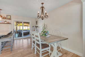 Dining room featuring light wood-style floors and a chandelier