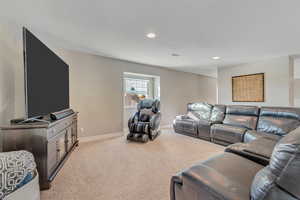 Living room featuring light colored carpet and recessed lighting