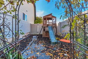 View of jungle gym with a fenced backyard and a gazebo