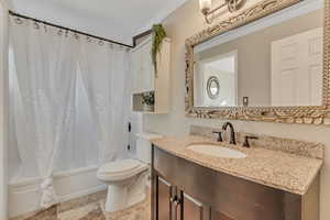 Bathroom with shower / tub combo with curtain, vanity, and crown molding