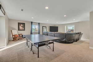 Game room with light colored carpet and recessed lighting