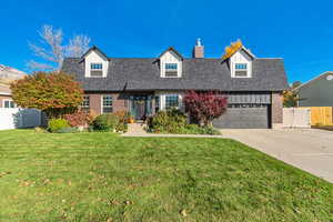 Cape cod house featuring brick siding, concrete driveway, a garage, a chimney, and roof with shingles