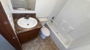 Bathroom featuring vanity, light tile patterned floors, and tub / shower combination
