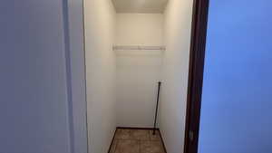 Walk in closet with light tile patterned floors