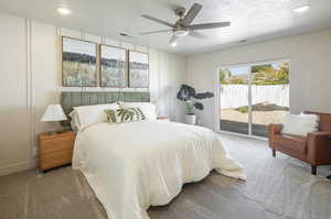 Bedroom featuring carpet flooring, access to exterior, a textured ceiling, a ceiling fan, and recessed lighting