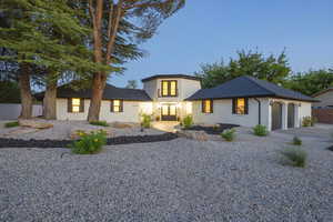View of front of home featuring brick siding, concrete driveway, and a garage