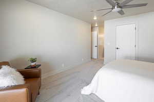 Bedroom featuring carpet, a textured ceiling, and ceiling fan