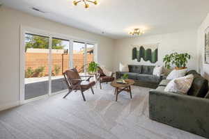 Carpeted living area with a textured ceiling