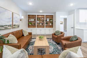 Living area featuring light wood-type flooring and recessed lighting