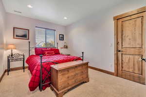 Bedroom with light carpet and recessed lighting