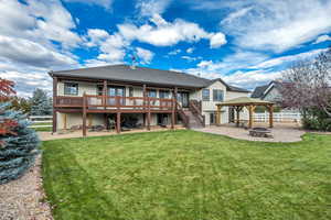 Rear view of house with an outdoor fire pit, a patio, stucco siding, a wooden deck, and stairway