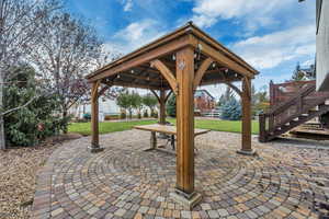 View of patio / terrace with stairs and a gazebo