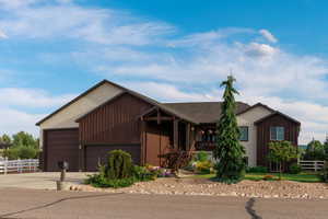 View of front facade with driveway, a garage, and a porch