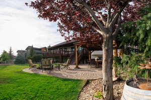 View of yard featuring a patio, stairs, and a deck