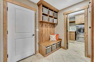 Mudroom featuring washer / dryer and light tile patterned flooring