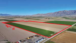Aerial view of property's location featuring a mountainous background and property parcel outlined