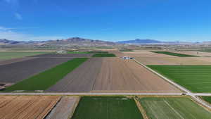 View of rural area featuring mountains and farmland