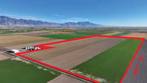 Overview of rural landscape featuring rows of crops and property boundaries highlighted