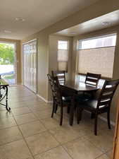 Dining area with a textured ceiling and light tile patterned floors