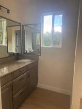 Bathroom with vanity and dark wood-style floors