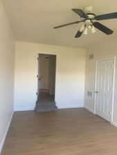 Spare room featuring wood finished floors and ceiling fan