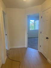 Hall with wood finished floors and baseboards