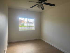 Spare room featuring light wood finished floors and ceiling fan