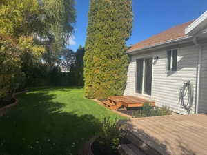 View of green lawn with a deck