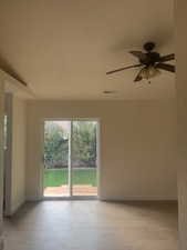 Empty room featuring a ceiling fan and light wood-style flooring