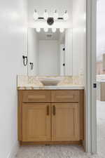 Bathroom featuring tasteful backsplash and vanity