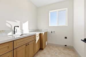 Laundry area featuring hookup for a washing machine, electric dryer hookup, cabinet space, and light tile patterned floors