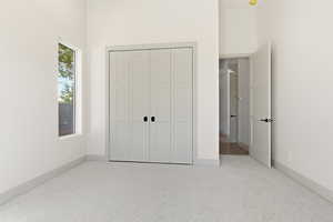 Unfurnished bedroom with carpet floors and a closet