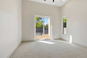 Empty room with carpet flooring and a ceiling fan