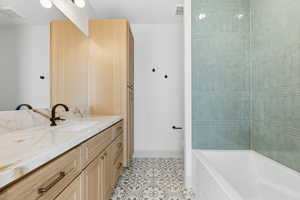Full bathroom featuring vanity and light tile patterned floors