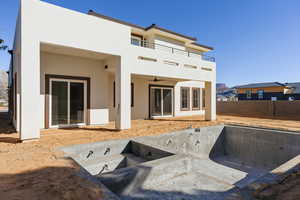 Rear view of house with a patio, ceiling fan, and stucco siding