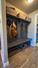 Mudroom with wood finished floors and a textured ceiling