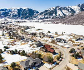 Snowy aerial view with a residential view and a mountain view