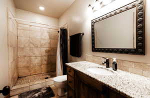 Bathroom with a stall shower and vanity