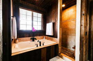 Bathroom featuring a bath and a shower stall